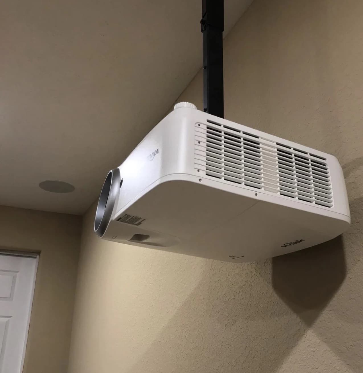 Real ceiling-mounted projector installed in a finished media room