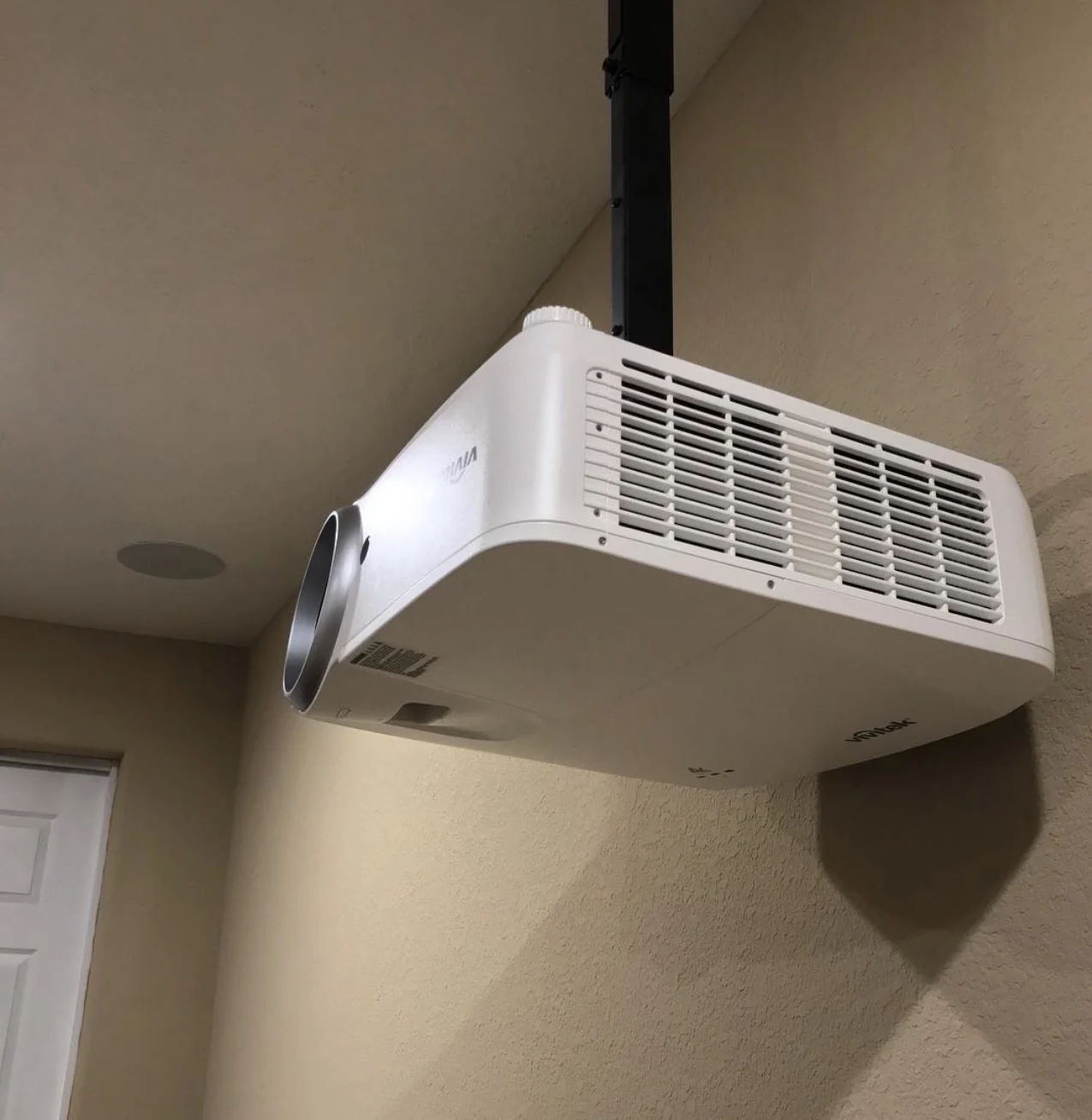 Real ceiling-mounted projector installed in a finished media room