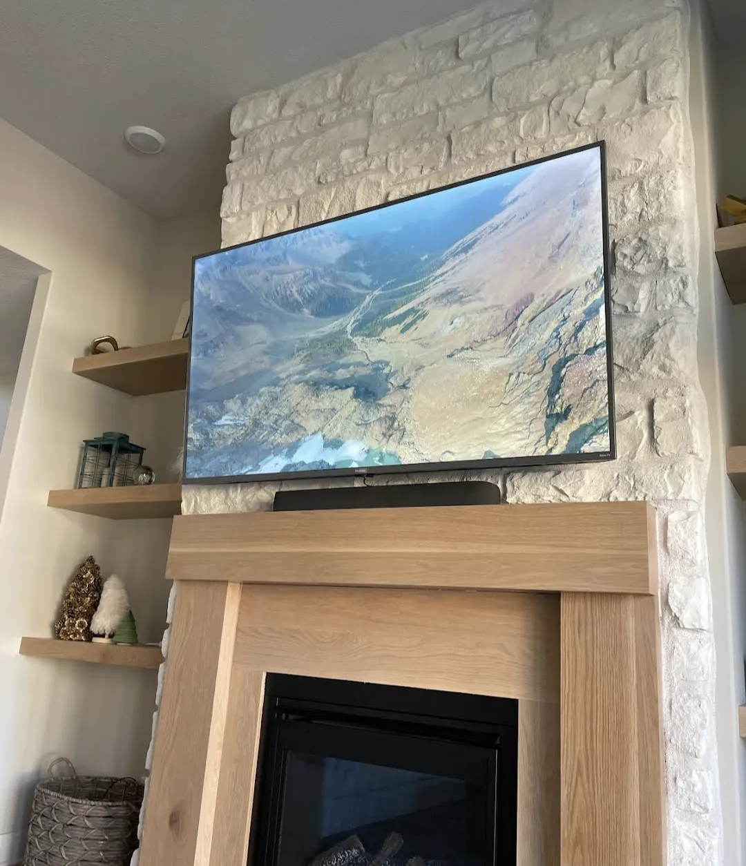 Professional TV mounting with concealed wiring, soundbar, in-wall speakers, and organized AV equipment