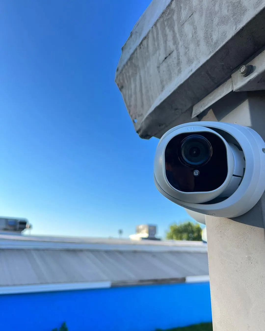 Real exterior security camera installed on a commercial building
