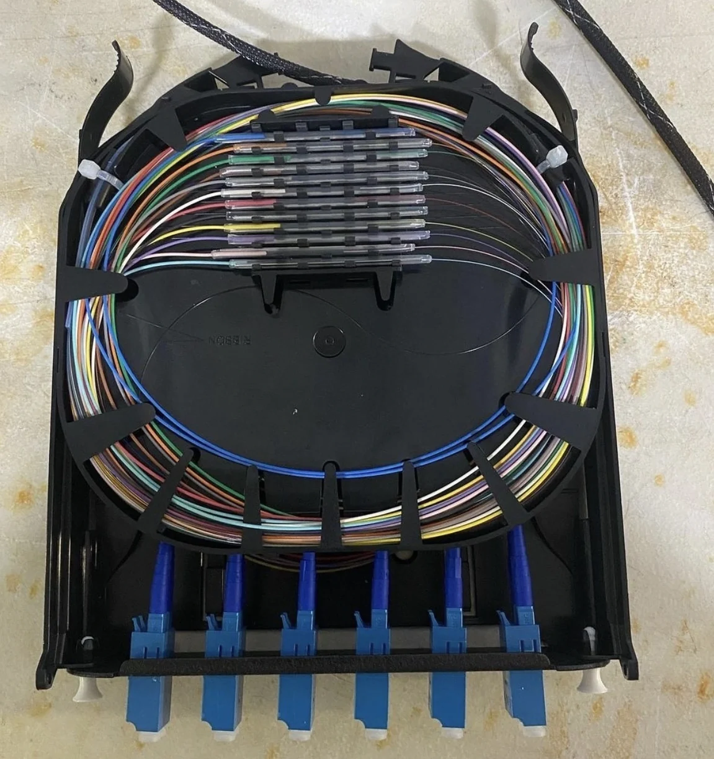 Organized fiber-optic strands and connectors inside a termination enclosure